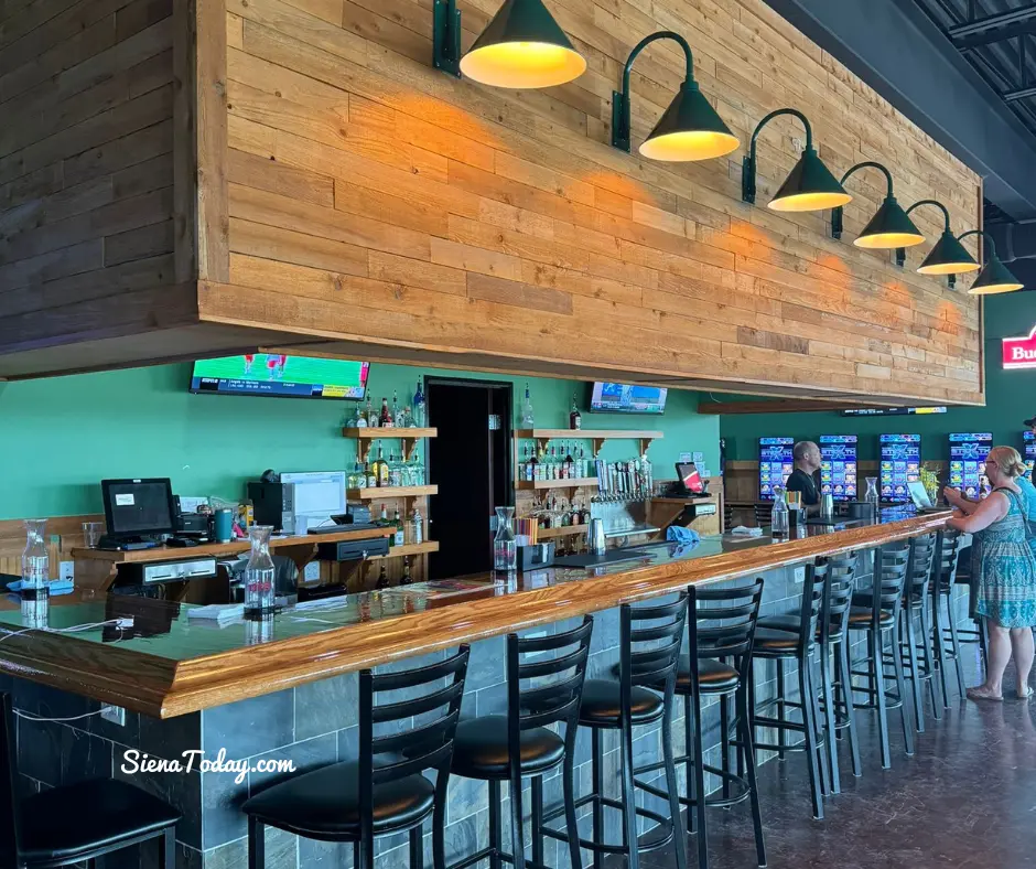 The long wood bar inside Pflutto's Tavern in Hutto