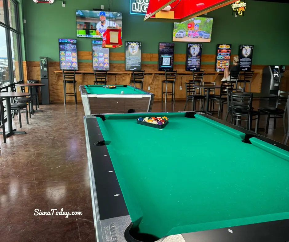 Two pool tables and wall-to-wall televisions inside Pflutto's Tavern in Hutto