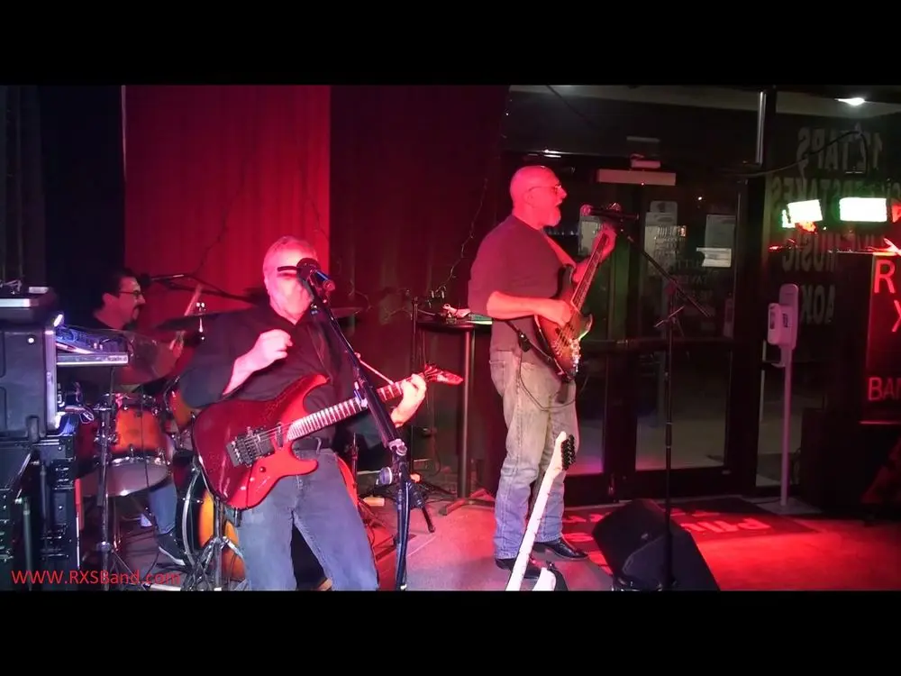 A live band performing on the stage at Pflutto's Tavern