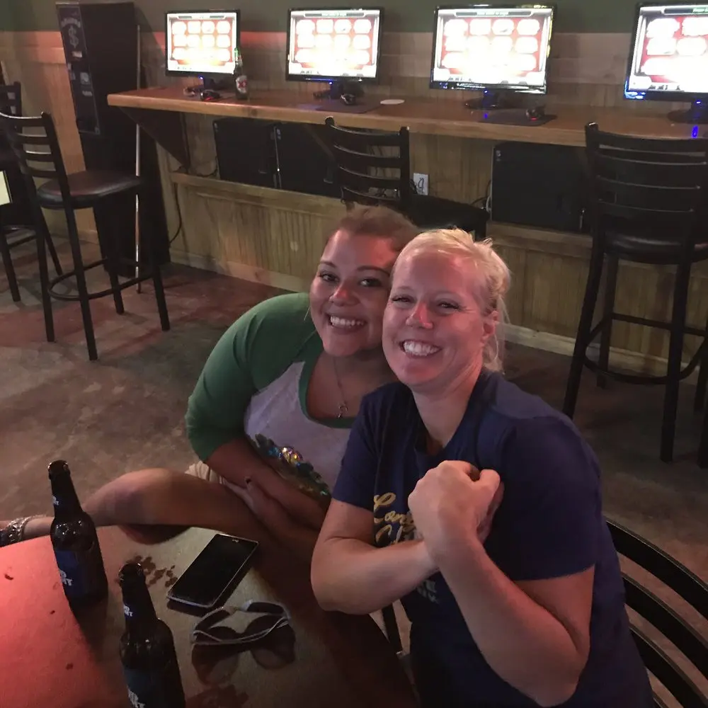 Friends smiling together during a night at Pflutto's Tavern
