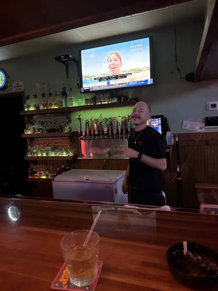 A bartender behind the taps at Pflutto's Tavern